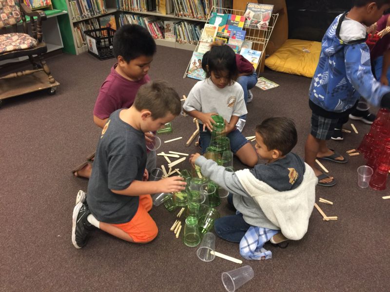 Students building with cups