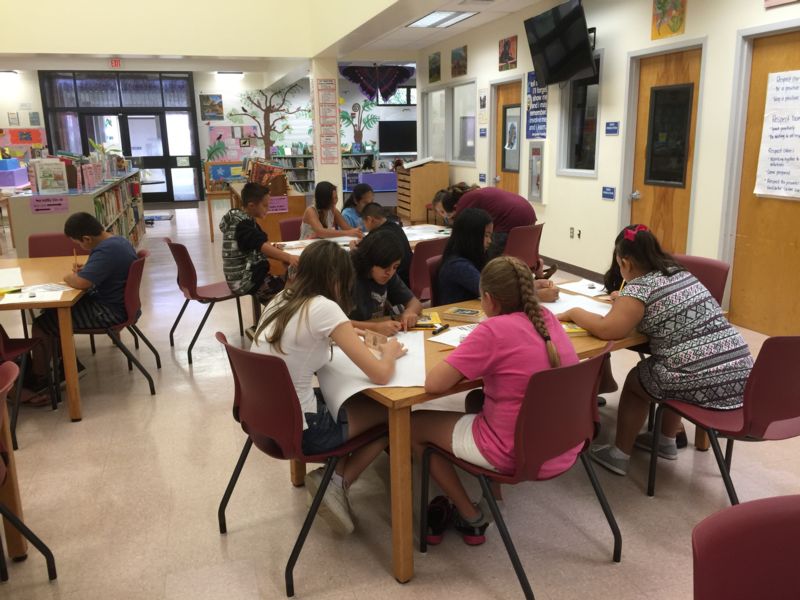 Kids reading at KEO